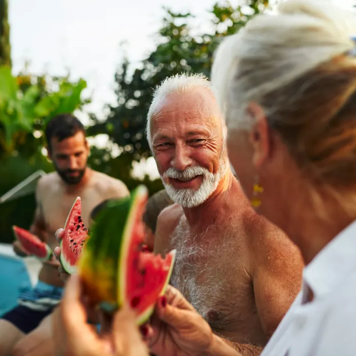 seniors eating watermelon poolside