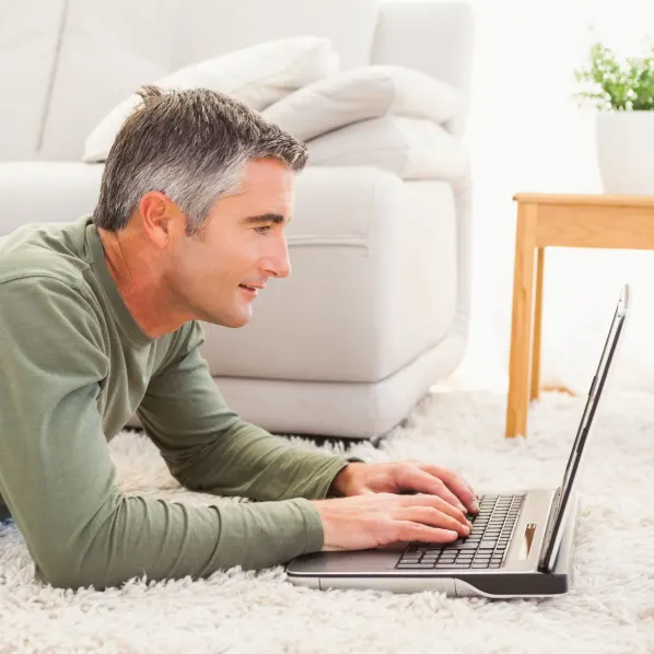 senior man on the floor with laptop