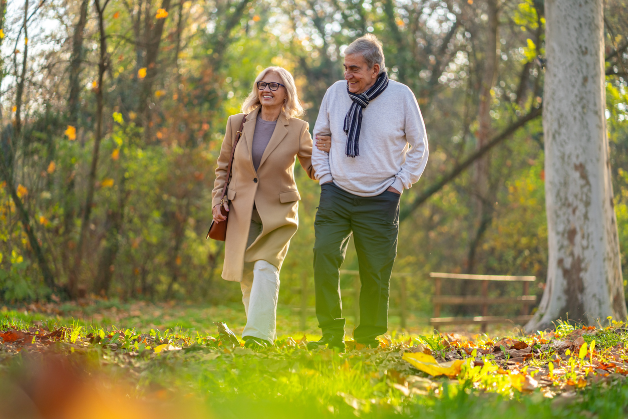 Senior couple in a walk outside during the fall